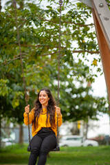 young woman on park swing