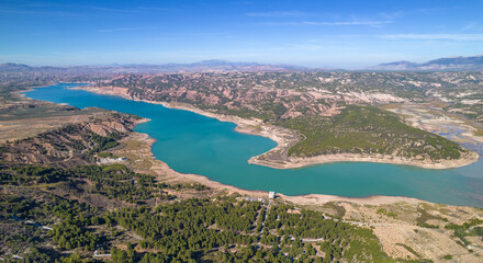 Fototapeta na wymiar Reservoir at full capacity. Aerial view of a water reserve for human use. Water reserves for human consumption. Andalusia. Spain.