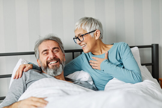 couple senior bed woman man home wife husband love together elderly caucasian adult happy retirement mature male old bedroom smiling resting retired aged relaxation leisure lying relationship