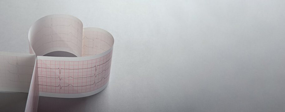 Ambulatory electrocardiogram (EKG or EKG) tape of a person recording the front view. Folded in the shape of a heart. One of the mandatory examinations of a cardiologist