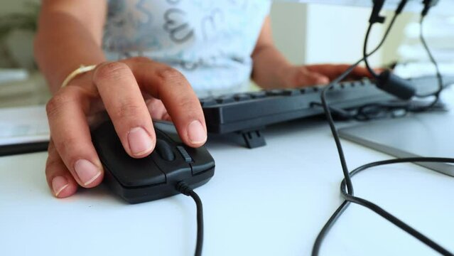 hand of an office worker on a computer mouse. a woman works at a computer in the office. High quality 4k footage