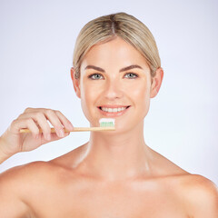 Portrait, woman and brushing teeth in studio for healthy dental wellness on background. Face of female model, bamboo toothbrush and cleaning mouth for fresh breath, oral hygiene and care for smile