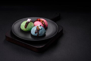 Delicious sweet colorful mochi desserts or ice cream with rice dough and toppings