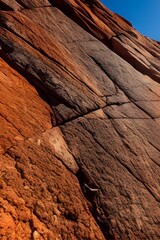 Obraz premium Dark red-orange-brown rock texture with cracks. Close-up. Rough mountain surface. Stone granite background for design. Nature.