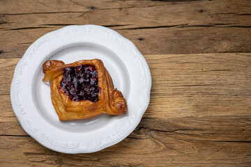 Delicious flavored pastries on a wooden table.  Close up