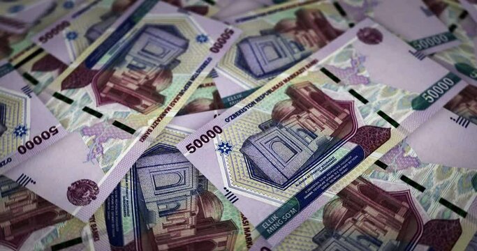 Uzbekistan Sum growing pile of money. UZS banknotes loop rotaring. Seamless and looped background concept of finance, economy crisis, inflation and business.