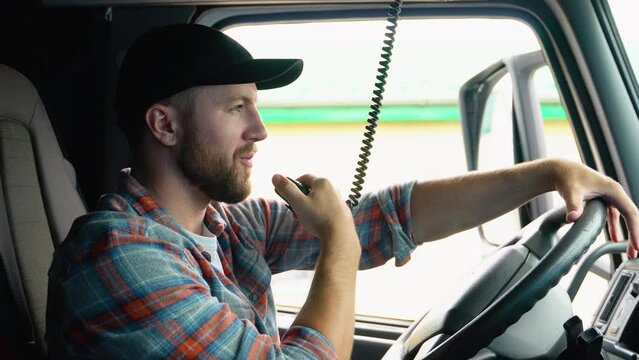 Truck Driver Making Talking Through Radio. Semi Truck