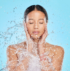 Skincare, water and face of woman on blue background for wellness, healthy skin and cleaning in...