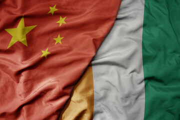 big waving national colorful flag of china and national flag of cote divoire .