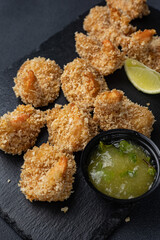 Delicious delivery of seafood fries with sauce.  Close up