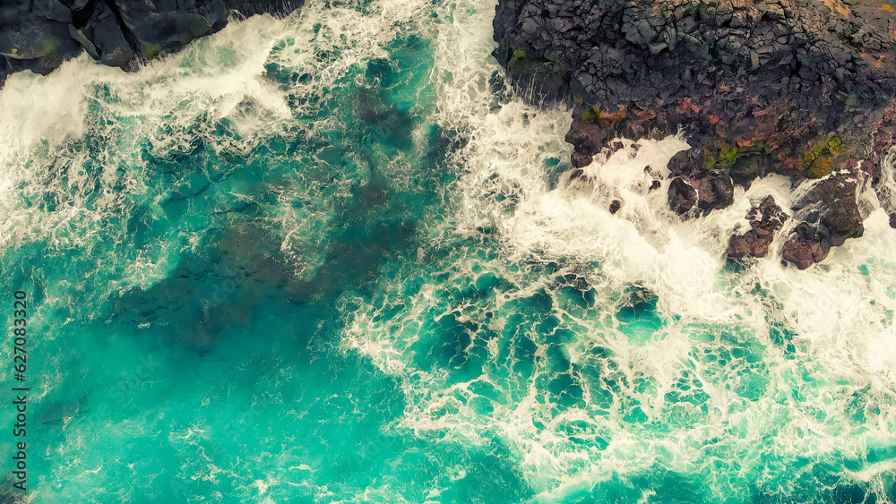 Sticker turbulent waters near a rocky shoreline, amazing aerial view from drone