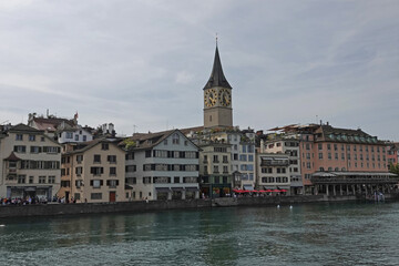 Fototapeta na wymiar Old Town Zurich, Switzerland is shown during the day, with the Limmat River in the foreground.
