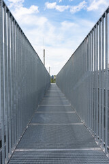 Gray galvanized steel fence close-up. galvanized gray nets protect the industrial building. Blue...