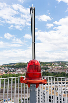 Signal beacon on the building. Red warning light on the building. Alarm equipment is installed on the building.