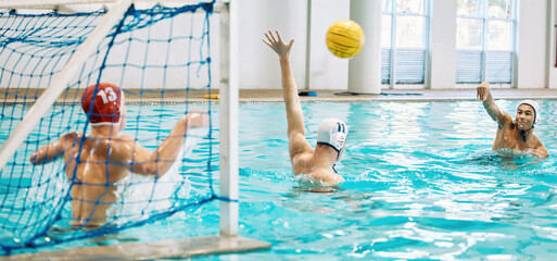 Teenager, boys and team, water polo and playing game with sports, action and energy in indoor...