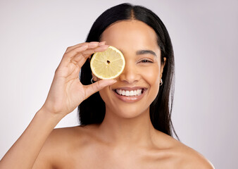 Happy woman, portrait and lemon for natural vitamin C, citrus or healthy nutrition against a grey...