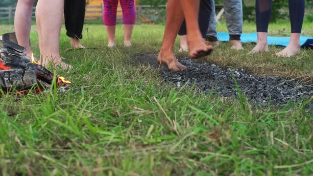 Coal walking or fire walking. Barefoot person on burned wood and hot embers. Training willpower and strength for healing. initiation and faith