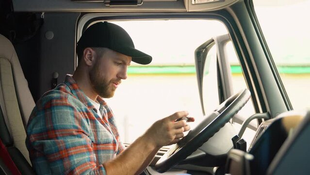 Professional trucker using truck gps navigation to transport and deliver goods to the destination. Transportation services