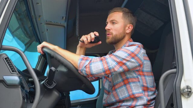 Trucker Preparing For Trip. Caucasian Men Talking on CB Radio. Truck Driver Job