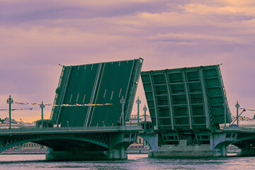 Green drawbridge over a river with raised spans, toned image.