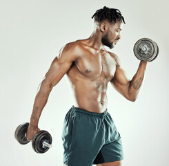 Fitness, strong and black man with dumbbells, exercise and wellness against studio background. Male...