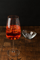 Aperol spritz cold summer cocktail with aperitif, prosecco, ice in a glass on the white background. Copy space for text