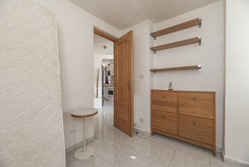 The bedroom has a mattress leaning against the wall