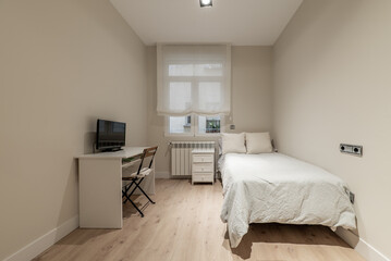 Bedroom with a single bed, white wooden furniture