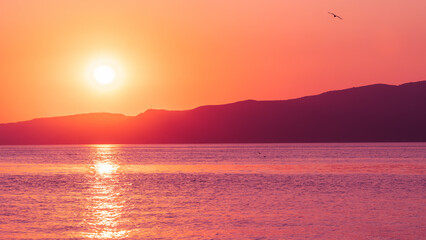 Sunset landscape. Sunset over sea and mountains. Colorful nature banner concept. Nature wallpaper