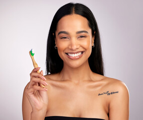 Happy woman, portrait and teeth with toothbrush for dental, cleaning or hygiene against a grey...