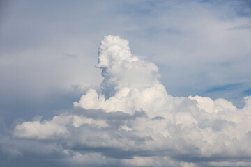 white fluffy clouds standing out against  a blue sky