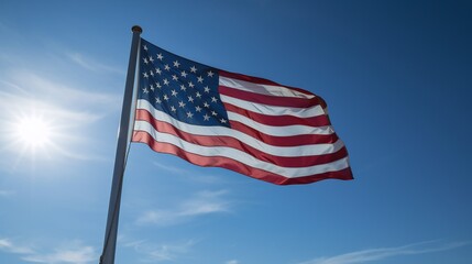 US American flag weaving on pole blue sky background