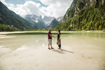 Beautiful traveler in front of lago di landro Italy