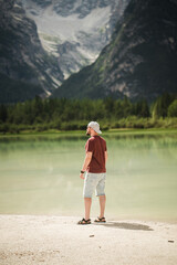 Beautiful traveler watchin the mountains at Lago di Landro