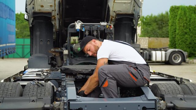 Professional truck mechanic working in vehicle repair service