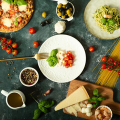 Italian flag made of food concept. Italian caprese salad made of cherry mozzarella, basil leaves...