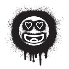 Smiling face emoticon graffiti with black spray paint .