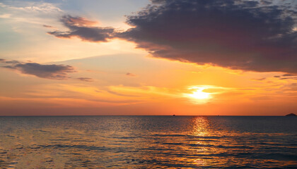 Obraz premium Sunset sky clouds vertical over sea in the evening with colorful orange sunlight reflect on the sea landscape with summer travel concept