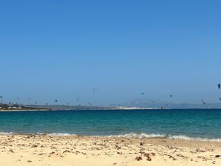 view from the Playa Valdevaqueros beach over the Atlantic with many windsurfers with the city of Tarifa and the mountain Jbel Musa in Morocco on the horizon, Strait of Gibraltar, Andalusia, Spain