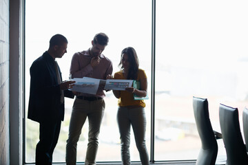 Making sure theyre prepped for the meeting. Cropped shot of three businesspeople talking in the boardroom.