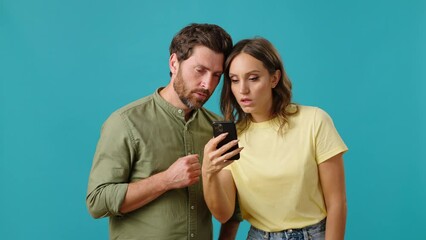 Man and woman rejoice receiving win notification on phone
