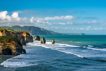 The rock formations known as The three sisters at Tongaporutu beach at high tide on the Taranaki coastline