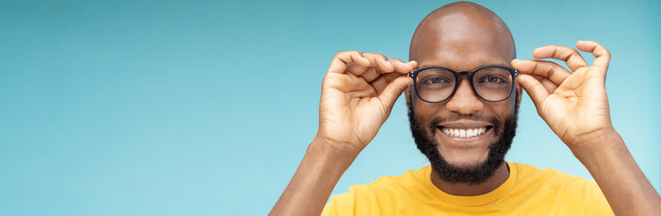 Black man, portrait or vision glasses on blue background, isolated mockup or wall mock up for eyes...