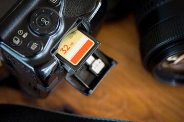 inserting a memory card into a camera - obrazy, fototapety, plakaty
