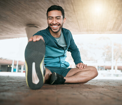 Man, stretching and foot for workout and fitness in the outdoor for wellness in the city. Male athlete, stretch and legs while sitting for training and exercise for sports competition in parking.