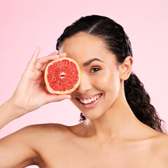 Beauty, grapefruit and face of a woman with skin care, dermatology and natural glow. Portrait of a happy young female aesthetic model with fruit for vitamin c, cosmetics or healthy diet for wellness