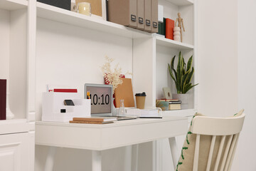 Cozy workspace with laptop on wooden desk at home