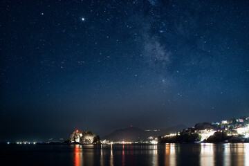 Fototapeta na wymiar Starry night over Pontikonisi island in Corfu, Greece