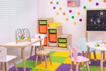 Stylish kindergarten interior with toys and modern furniture