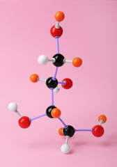 Molecule of sugar on pink background. Chemical model